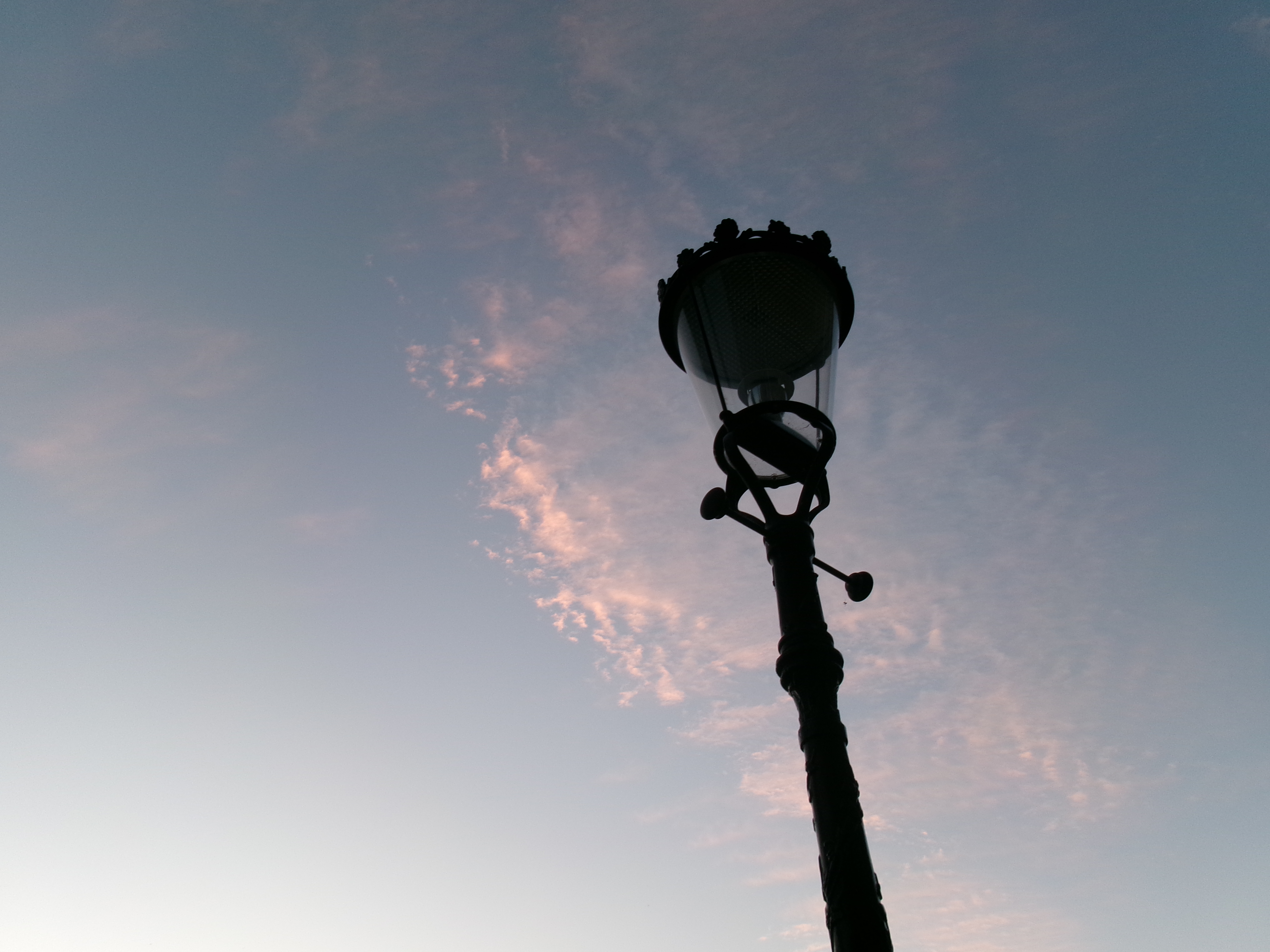 blue sky with wispy clouds and a lantern